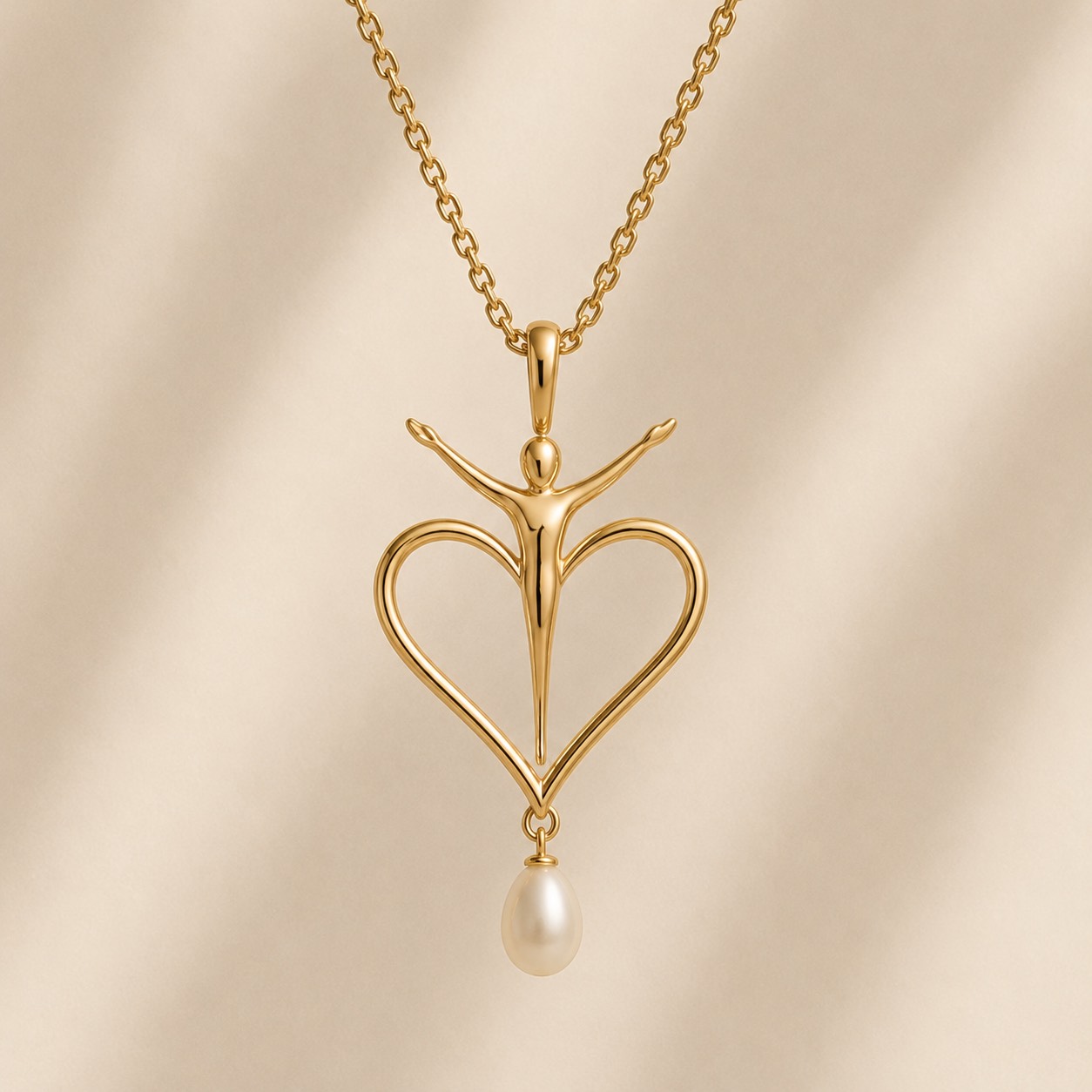 Christ Risen pendant in gold with triumphant Christ figure and pearl drop